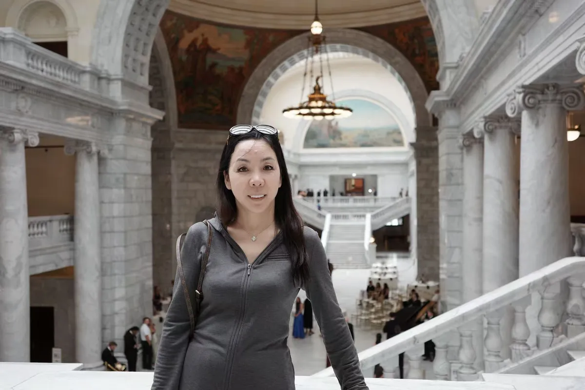 June Zhang inside a historic public building abroad