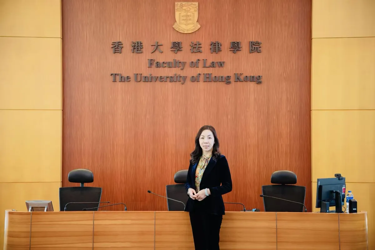 June Zhang standing in a courtroom-style hall of the Faculty of Law, The University of Hong Kong