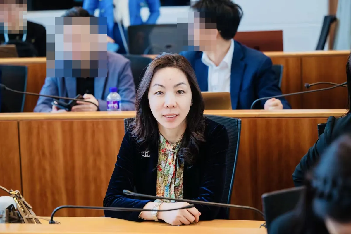 June Zhang seated in a lecture room at the Faculty of Law, The University of Hong Kong