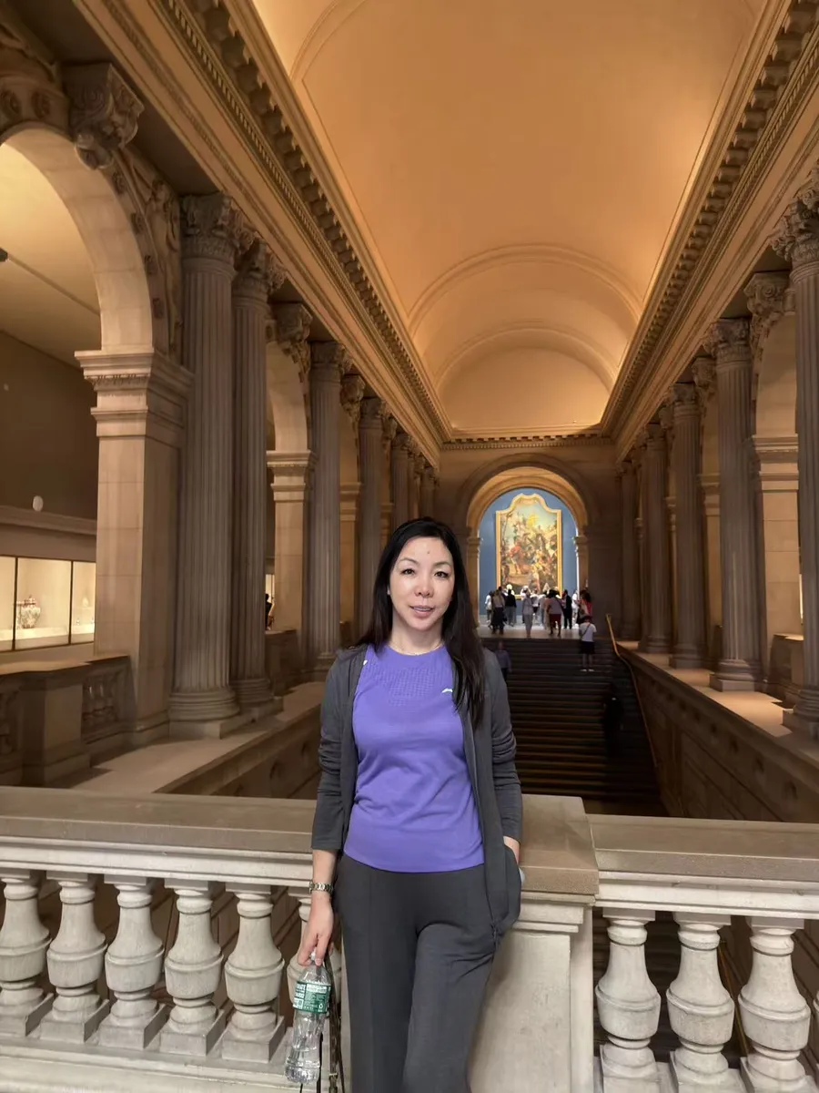 June Zhang on the main staircase of the Metropolitan Museum of Art in New York